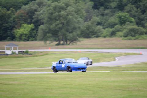 A blue Mazda Miata on Nelson Ledges Road Course